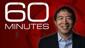 西裝男子微笑，背景有 '60 MINUTES' 和時鐘。