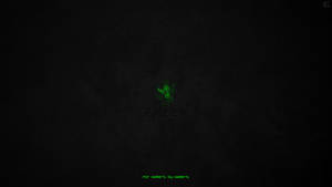 Razer標誌在深色紋理背景上發出綠光，附有為玩家而設的標語。 — 遊戲玩家標誌 壁紙