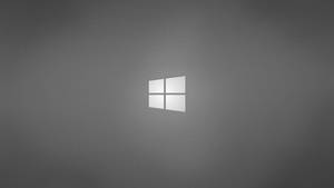 Windows標誌在灰色漸變背景上柔和發光 — 桌面 壁紙