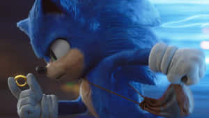 索尼克（Sonic the Hedgehog）在藍色模糊中疾馳時握著一個金色指環。 — 音速小子 壁紙