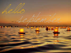 日落時燈籠浮在水面，附有文字 hello september — 九月 壁紙