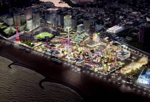 夜間燈火通明的海岸遊樂園，有雲霄飛車和城市建築。 — 夜晚 壁紙