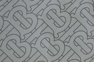 帶有重複交織B字母組合圖案的灰色布料。 — Burberry 壁紙
