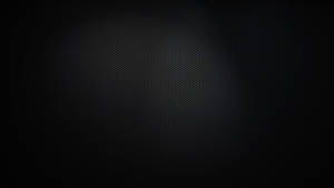 深色紋理背景，帶有微妙的漸變和細點圖案。 — 純黑 壁紙