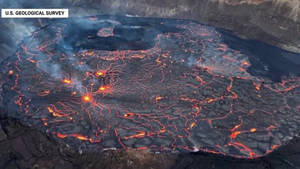 火山口有發光熔岩流過裂縫地面。 — 1920x1080 壁紙