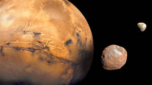 火星與兩顆小行星漂浮在太空的黑暗中。 — 火星人布魯諾 壁紙