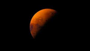 火星在太空中發出橙色光芒，表面細節可見。 — 火星人布魯諾 壁紙