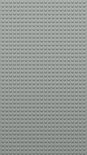 灰色LEGO底板，帶有重複的圓形凸點用於搭建。 — 紋理 壁紙