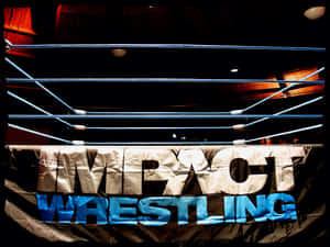 摔角擂台，在明亮聚光燈下帶有 Impact Wrestling 橫幅。 — 摔角 壁紙