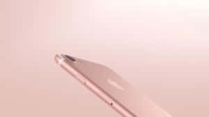 玫瑰金色iPhone在柔和粉紅色背景上帶有Apple標誌 — 玫瑰金 壁紙