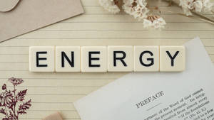 奶油色瓷磚在橫線紙上拼出ENERGY，配有乾花和書頁。 — 高清 壁紙