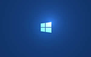 Windows標誌在藍色漸變背景上發光 — Windows 11 4K 壁紙