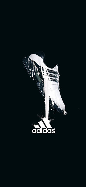 白色Adidas足球鞋在黑色背景上帶有顏料滴落。 — 省電 壁紙