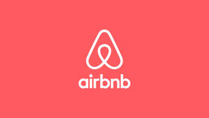 珊瑚粉紅色背景上的白色Airbnb標誌 — Off white 標誌 壁紙