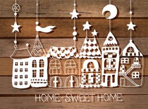 剪紙房屋和星星掛在木頭上，帶有home sweet home文字。 — 甜蜜的家 壁紙