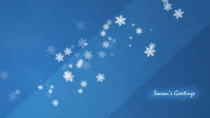 雪花落在帶有「Season's Greetings」文字的藍色漸變背景上。 — 慶祝 壁紙