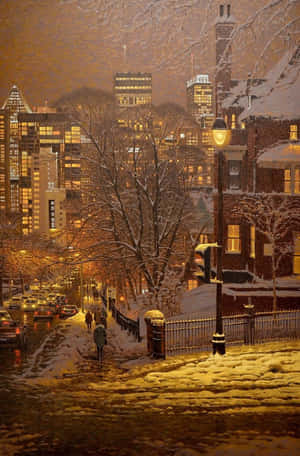 夜晚白雪覆蓋的城市街道，發光的路燈和建築物。 — 冬季風景 壁紙