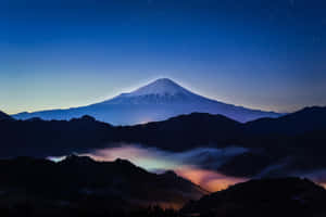 富士山在星空下，暮色中帶有發光的雲彩 — 富士山 壁紙