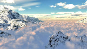 白雪覆蓋的山峰在日出時高聳於雲海之上。 — 山脈 壁紙