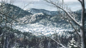 透過光禿的樹枝看到的冬日雪山中被雪覆蓋的村莊。 — 鬼滅之刃 壁紙