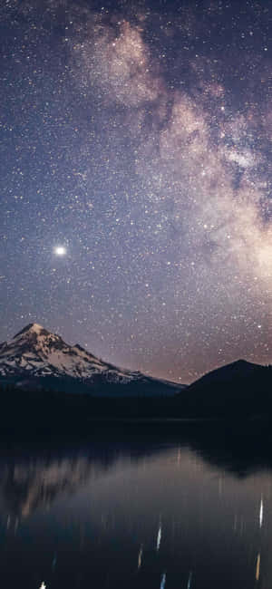雪山和湖泊反射出帶有銀河的星空夜空 — Moto E13 壁紙