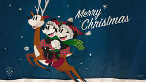 米奇和米妮老鼠在雪夜場景中騎著馴鹿，帶有 'Merry Christmas' 字樣。 — 午夜 壁紙