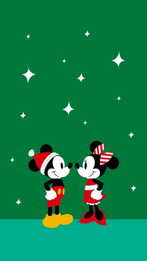 米奇和米妮老鼠在閃爍星星下穿著節日服裝。 — 迪士尼聖誕節 GIF 壁紙