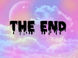 「The End」文字在夢幻粉彩天空上滴落黑色墨水，有月亮和雲朵。 — 哥德美學 壁紙