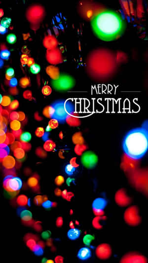 帶有 Merry Christmas 文字的彩色散景聖誕燈。 — 聖誕節 iPhone 壁紙