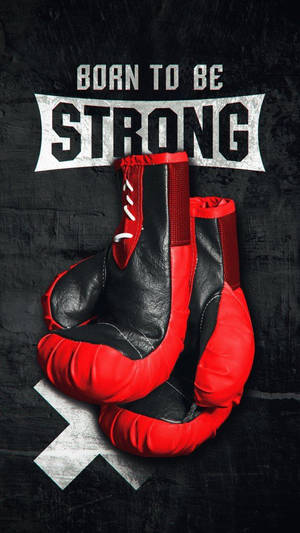 紅色和黑色的拳擊手套，在深色紋理牆壁上帶有「Born to be Strong」文字。 — 運動 壁紙