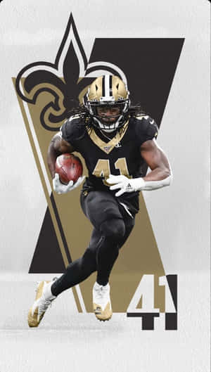 身穿聖徒隊球衣的足球員持球奔跑 — Alvin Kamara 壁紙