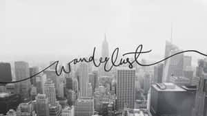 黑白城市景觀，帶有「Wanderlust」文字疊加。 — 城市風景 壁紙