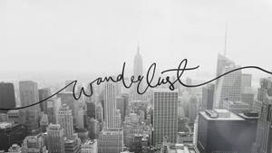 黑白城市景觀，疊加有「Wanderlust」草書文字。 — 城市風景 壁紙
