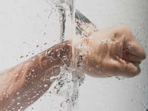 一隻手握成拳頭穿過水流。 — 情侶擁抱 壁紙