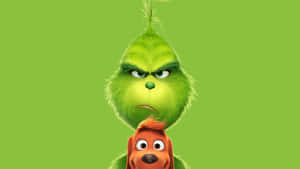 聖誕怪傑 Grinch 和他的狗 Max 在綠色背景下帶著憤怒的表情。 — 聖誕老人 壁紙
