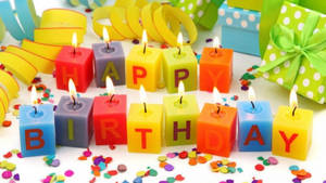 生日蠟燭拼出 happy birthday，伴隨著五彩紙屑和禮物。 — 生日祝福 壁紙