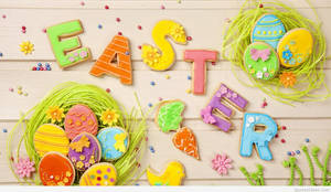 復活節餅乾拼出單詞 Easter，並配有裝飾雞蛋和花朵。 — 復活節 壁紙