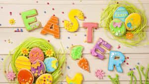 復活節餅乾拼出單詞 Easter，並配有裝飾雞蛋和花朵。 — 16:9 壁紙