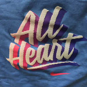 藍色T恤，帶有珠子組成的 'All Heart' 文字和紅色Nike勾勾。 — iPad Pro 11 壁紙