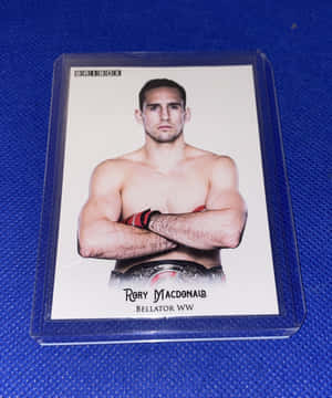 Rory MacDonald 戰士卡，藍色背景上配有冠軍腰帶。 — Motorola Razr Ultra 2025 壁紙