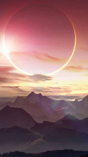 暮色中發光行星環下的超現實山脈。 — 月落 壁紙