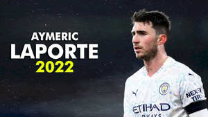 Aymeric Laporte 身穿曼城球衣，以星空夜空為背景，並有2022年文字。 — 運動 壁紙