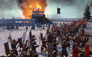 冬季戰鬥中，武士軍隊在雪中向燃燒的堡壘衝鋒。 — 混沌武士 壁紙