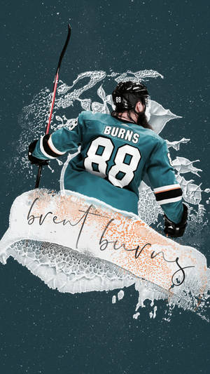 身穿青綠色球衣的冰球運動員 Brent Burns 舉起球棍衝破冰層。 — 運動 壁紙