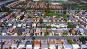 郊區住宅區的空中傾斜移位照片，有房屋和街道。 — 鄰里 壁紙