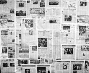 牆壁被重疊的報紙剪報覆蓋，有標題和照片。 — Old Paper 壁紙