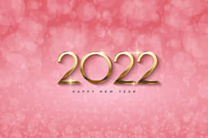 金色2022字樣在粉紅色散景背景上閃爍，用於新年慶祝。 — 新年快樂 2020 壁紙