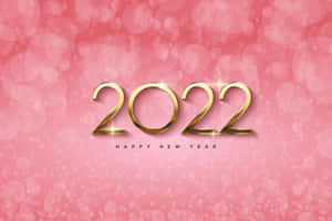 金色2022文字搭配閃光，在粉紅散景背景上慶祝新年。 — 新年快樂 壁紙