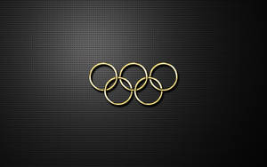 金色奧運五環在黑色穿孔金屬表面上。 — 奧運 壁紙