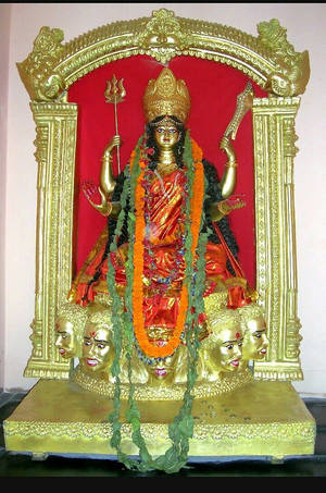 金色印度教杜爾迦女神雕像，有多臂和多頭，飾有花環。 — 雕塑 壁紙